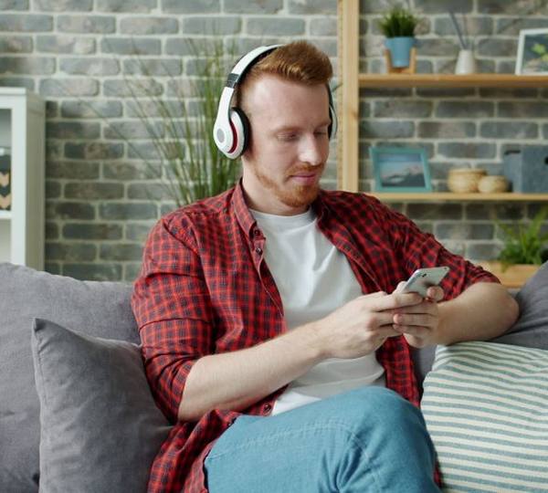 A man relaxing at home after sorting out his finances